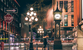 A photo of Vancouver's Gastown at night, showing the iconic Steamclock.