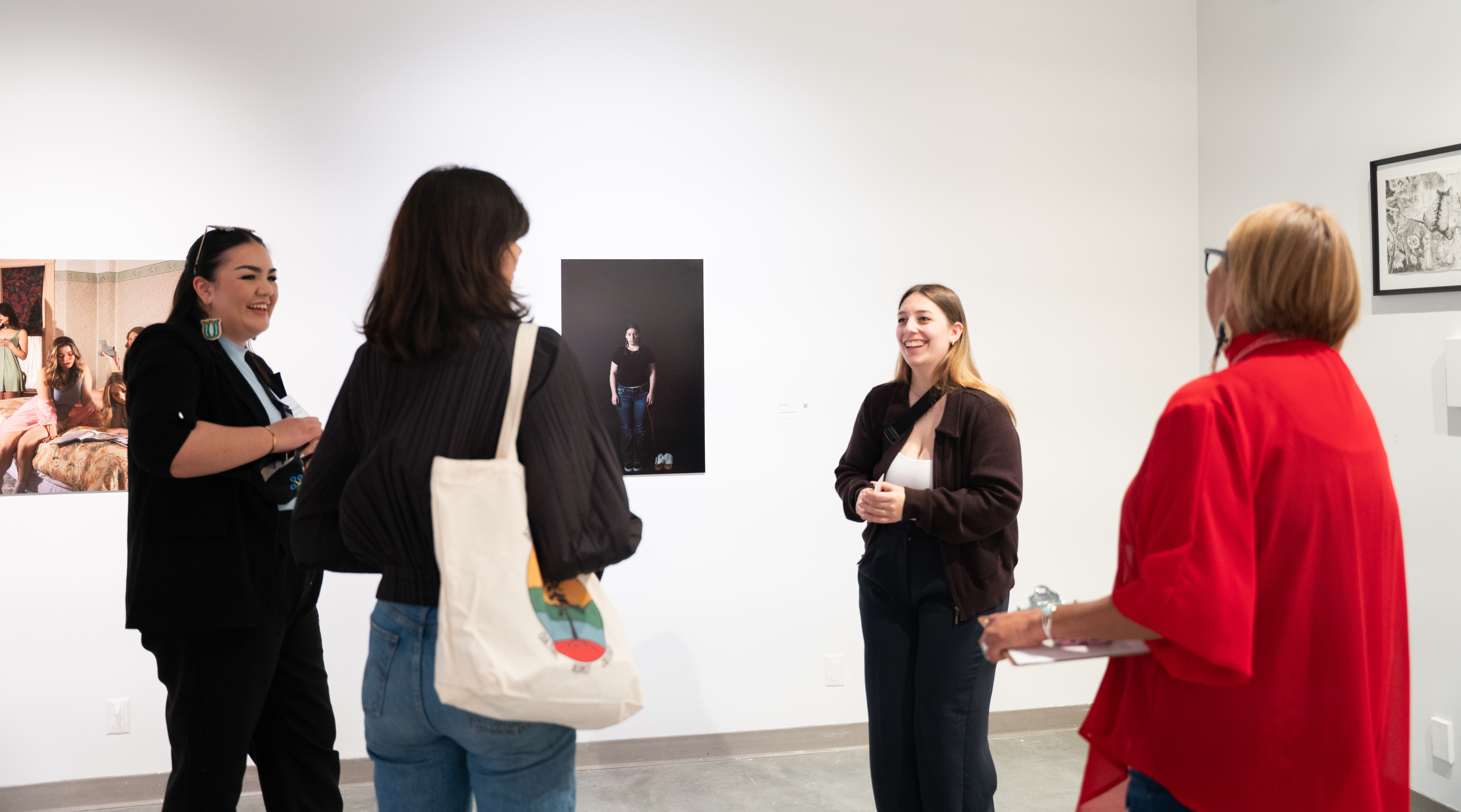 A group of four people smile and chat