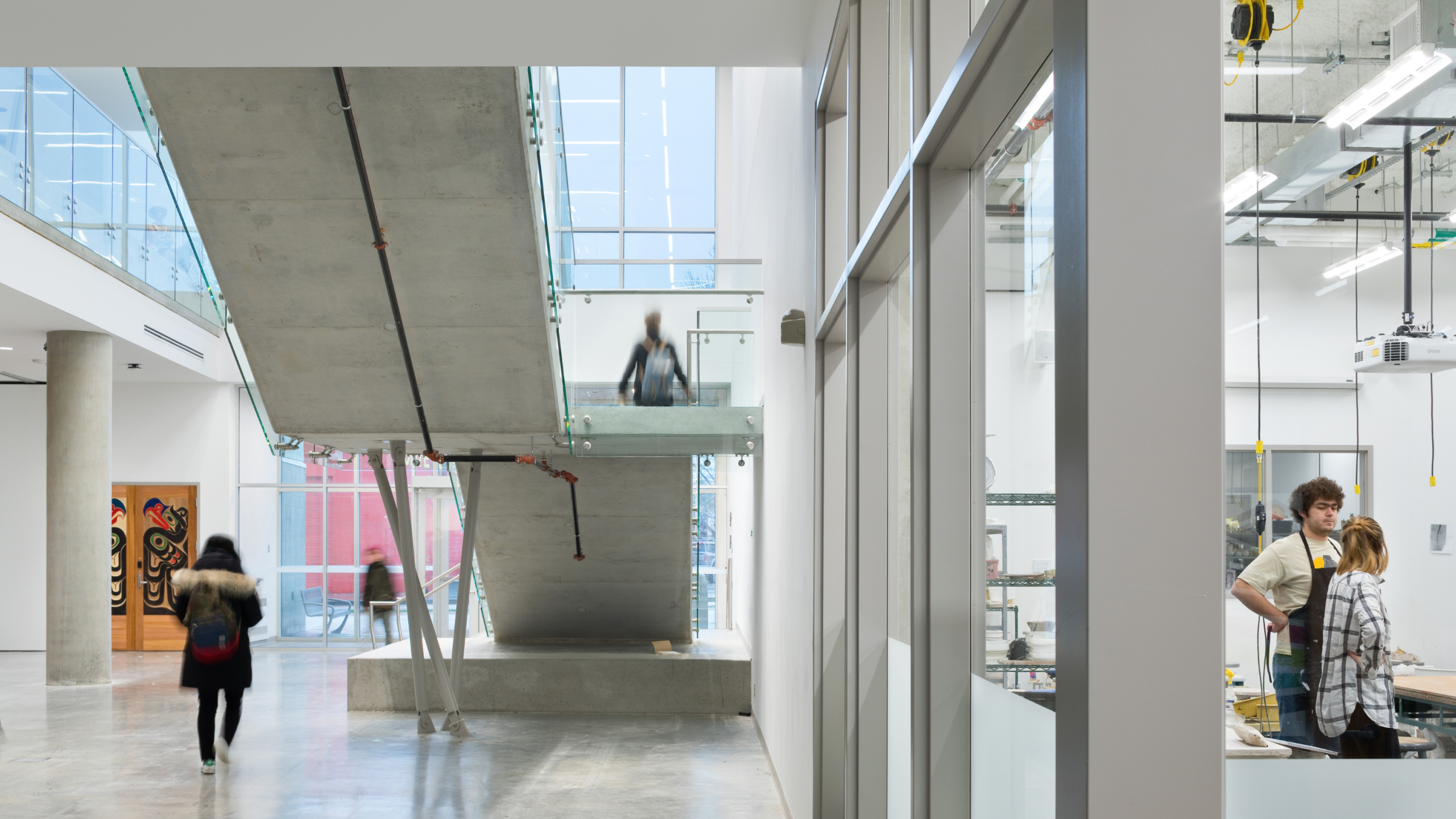 A view of the first floor of ECU's campus building, showing students walking through the halls.