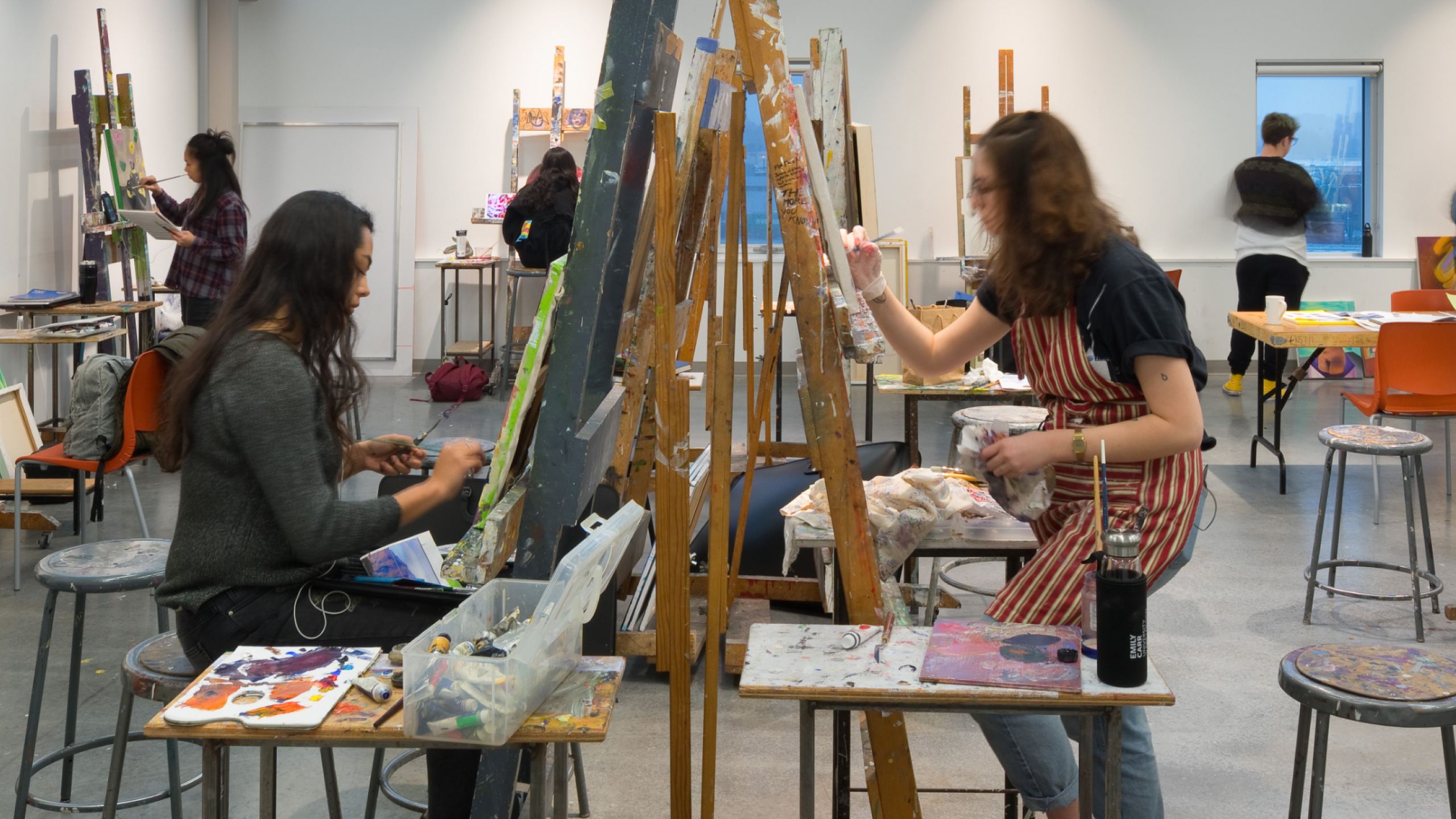 Students work at canvases in ECU's painting studio.