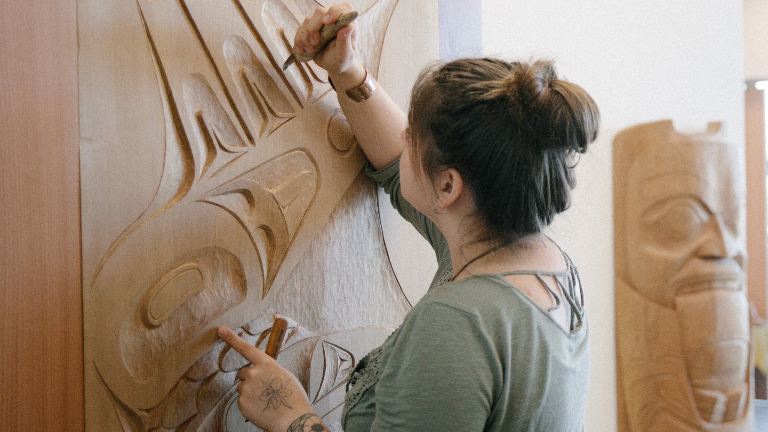 A student puts the finishing touches on a carved door.