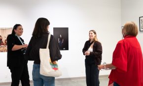 A group of four people smile and chat