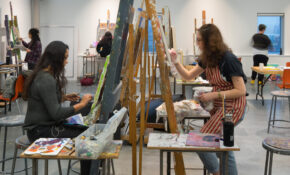 Students work at canvases in ECU's painting studio.