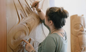 A student puts the finishing touches on a carved door.