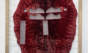 A red seal skin fur with colourful beading in three different places of the hide