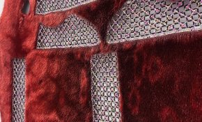 A closeup of thatched beading on a red seal skin hide